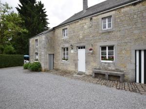 a stone building with a bench in front of it at Cozy Wéris cottage retreat in Weris +29 photos