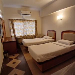 Postel nebo postele na pokoji v ubytování FabHotel Aura Inn - RR Nagar + 21 fotografií