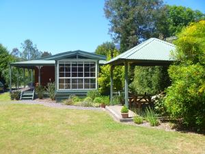 a garden with a pavilion and a picnic table at Sunburst Retreat in Eildon