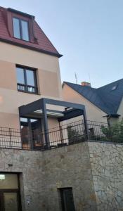 a large house with a stone wall and a fence at Rezidence Kotnov Tábor in Tábor +5 photos