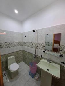 a bathroom with a toilet and a sink at Eagle Resort Hotel and Restaurant in Nārān +40 photos