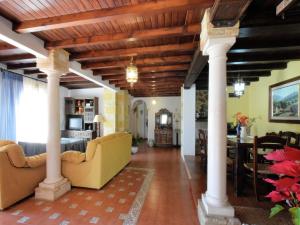 a living room with columns and a ceiling with beams at Holiday Home in Zagrilla Alta with Pool in Zagrilla
