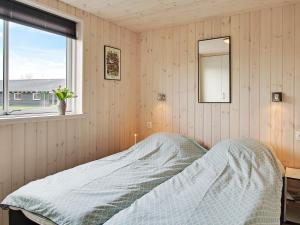 a bedroom with a bed with a mirror and a window at 5 star holiday home in Kappeln in Kappeln