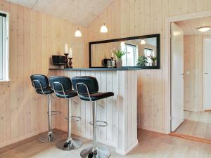 a bar with two chairs and a mirror at 5 star holiday home in Kappeln in Kappeln +10 photos