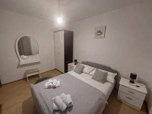 a bedroom with a large bed with two shoes on it at Apartment Dominik - Two Bedroom Apartment with Terrace and Sea View in Smokvica