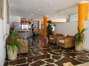 a lobby with chairs and potted plants in a building at Hotel Tibidabo in Bellaria-Igea Marina