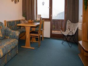 a living room with a table and a couch at Apartment in Hollersbach near Ski Slopes in Bramberg am Wildkogel