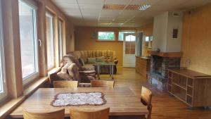 a living room with a couch and a table at Petronių sodyba in Rukliai