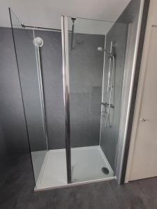 a shower with a glass door in a bathroom at Central 2-bedroom bunglow with double sofa bed in Carnoustie +12 photos