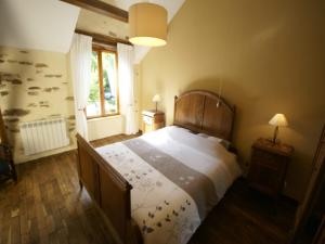 a bedroom with a large bed with a wooden headboard at Holiday Home in Limoges with Saltwater Pool in Châteauneuf-la-Forêt +32 photos