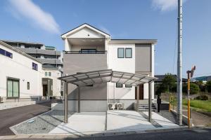 a building with a metal shelter in front of it at Fukuoka Airport 8 in Shime