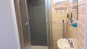 a small bathroom with a shower and a sink at Poilsiavietė Mano Maljorka in Šventoji +48 photos