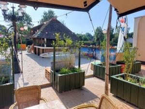 a patio with potted plants and a playground at Holiday home in Gramsbergen in Gramsbergen