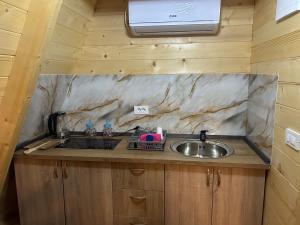 a kitchen with a sink and a window above it at Camp Danis in Plav