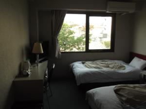 מיטה או מיטות בחדר ב-Jonai Hotel