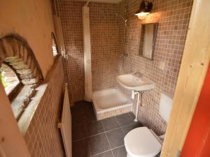 a bathroom with a sink and a tub and a toilet at Gypsy Caravan in Weideblick with Farm Animals in Bergen op Zoom +22 photos