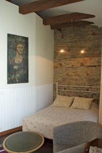 a bedroom with a bed and a brick wall at Kreutzhouse in Haapsalu