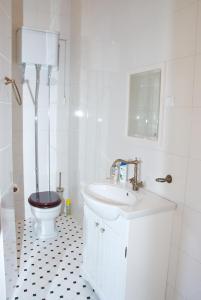 a white bathroom with a toilet and a sink at Kreutzhouse in Haapsalu
