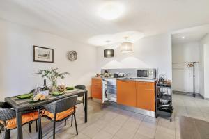 a kitchen and dining room with a table and chairs at Oasi Panoramica con piscina - Happy Rentals in Aldesago