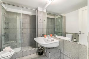 a bathroom with a sink and a shower at Oasi Panoramica con piscina - Happy Rentals in Aldesago