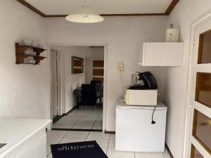 a kitchen with a white refrigerator and a microwave at Holiday Home in Margraten near Maastricht in Margraten