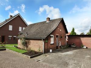 a red brick house with a driveway at Holiday Home in Margraten near Maastricht in Margraten