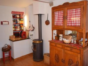 a kitchen with a stove in the corner of a room at Escape in Saint-Julien-du-Gua in Saint-Julien-du-Gua