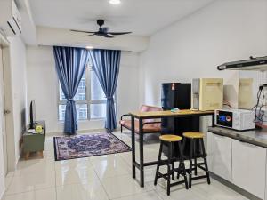 a kitchen and living room with a table and chairs at MIRAI Residences in Kajang +11 photos