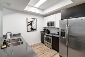 a kitchen with a stainless steel refrigerator and a sink at 2BR Miami Condo - Near Marina & Attractions in Miami