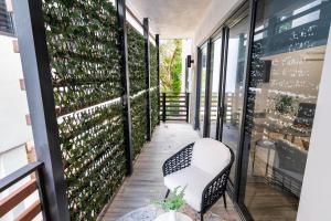a balcony with a bench and a wall of wine bottles at 2BR Miami Condo - Near Marina & Attractions in Miami