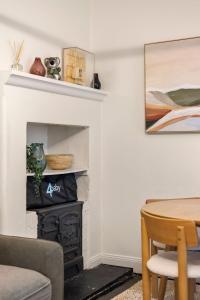 a living room with a fireplace and a table at Millers Point Retreat 5 Min Walk to Barangaroo in Sydney