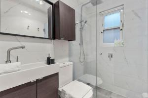 a bathroom with a shower and a toilet and a sink at Millers Point Retreat 5 Min Walk to Barangaroo in Sydney