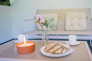 a table with a candle and a vase of flowers and cookies at Apartments Lian in Bled