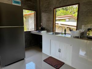 a kitchen with a sink and a refrigerator at Bantai Hideaway - House 1 in Baan Tai +17 photos
