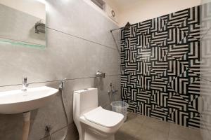 a bathroom with a toilet and a sink at Sri Ramakrishna Hotel in Bangalore