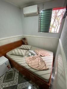 a small bed in a room with a window at Hotel jardim paulista in São Paulo