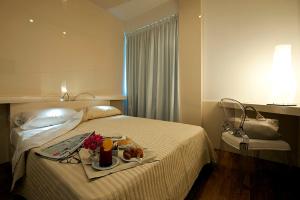 Postel nebo postele na pokoji v ubytování Hotel Excelsior