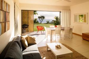 a living room with a couch and a table at Cap Ouest by Horizon Holidays in Flic-en-Flac