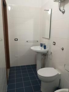 a bathroom with a toilet and a sink at TreDomus in Iglesias +14 photos