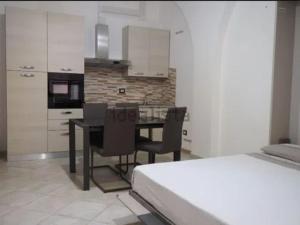 a kitchen with a dining room table and chairs at TreDomus in Iglesias