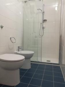 a bathroom with a toilet and a shower and a sink at TreDomus in Iglesias