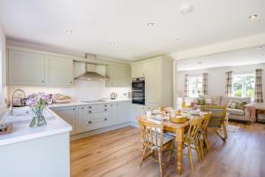 a kitchen and living room with a table and chairs at 3 Bed in Little Clacton oc-l32526 in Little Clacton