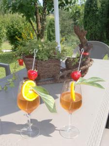 a table with two wine glasses with orange slices at B&B Dolomitincanto in Cesiomaggiore +80 photos