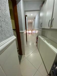 a hallway with a white tile floor in a room at Hotel jardim paulista in São Paulo +14 photos
