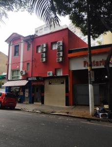 a red building on the side of a street at Hotel jardim paulista in São Paulo