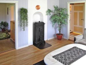 a living room with a stove in the middle of a room at 7 person holiday home in Bøstad in Alstad