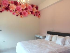a bedroom with a bed with a flower arrangement on the wall at Stick-On B&B in Shunan
