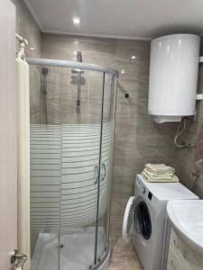 a bathroom with a shower and a washing machine at Nele in Zrenjanin +10 photos