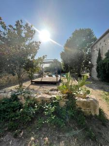 a park with a playground with the sun in the sky at Suites zen dans maison d'hôtes avec piscine intérieure et jardin in Ventenac-Cabardès