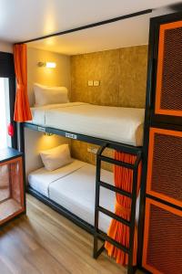 two bunk beds in a room with a ladder at Ubox samui hostel & Bungalow - Chaweng beach in Chaweng +19 photos